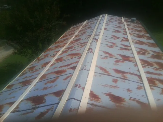 Rusted metal roof panels with new wood purlins before replacement — Storm Damage Roof Repair in Diamond by Roofing Brothers